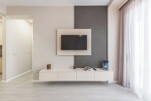 A modern bathroom with a large mirror, a vanity with a sink, and a decorative lantern. - Luxurious Panoramic Apartment (Tiranë)