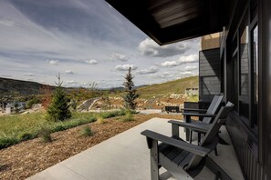 Step outside to your private covered patio and take in sweeping mountain views. Two Adirondack chairs invite you to unwind beneath the open sky, surrounded by peaceful natural beauty and fresh air. - Steamboats AMB104 | Newest Luxury Complex | Pool | A/C (Steamboat Springs)