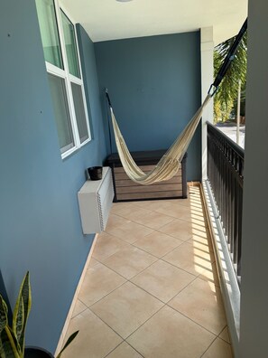 A balcony with a hammock, a window, and a radiator. - Little Corner of Paradise Sleeps 6, 2 Bath, 2 Room (Rincon)
