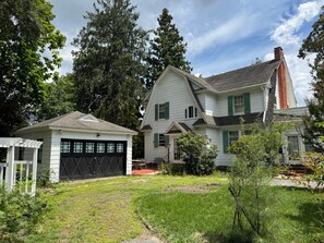 A two-story house with a garage and a small porch. - Camden at Monticello (Salisbury)