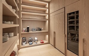 A modern kitchen with built-in shelves, a refrigerator, and various appliances. - Modern Muskoka made for Entertaining (Nipissing South (Utterson))