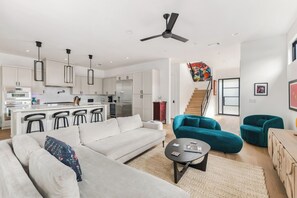A modern living space with a kitchen, dining area, and seating. - East Austin Skyline & Pool House ~Backyard BBQ~ (Austin)