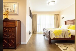 A bedroom with a bed, a dresser, a nightstand, and a window with curtains. - 3Br |stylish home | Game Park View Haven | Family friendly | Nairobi stay (Nairobi)