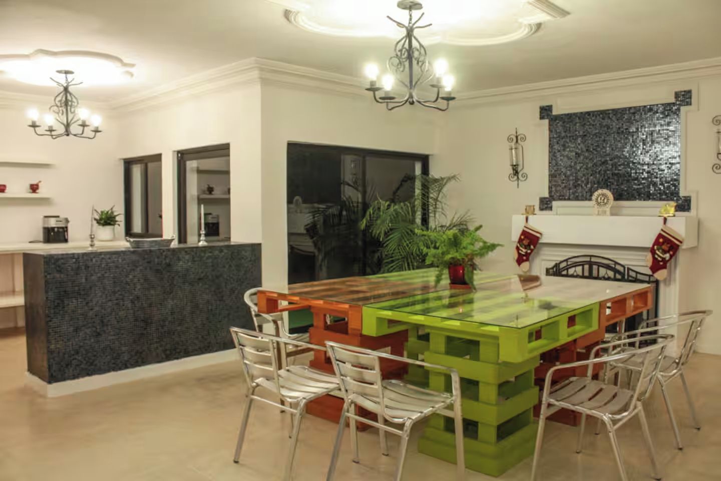 A modern kitchen with a central island, bar stools, and pendant lighting.