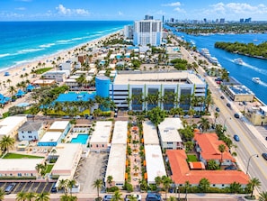 A coastal cityscape with a beach, a marina, and a mix of residential and commercial buildings. - Beachside Studio I Pool I Full Kitchen (Hollywood)