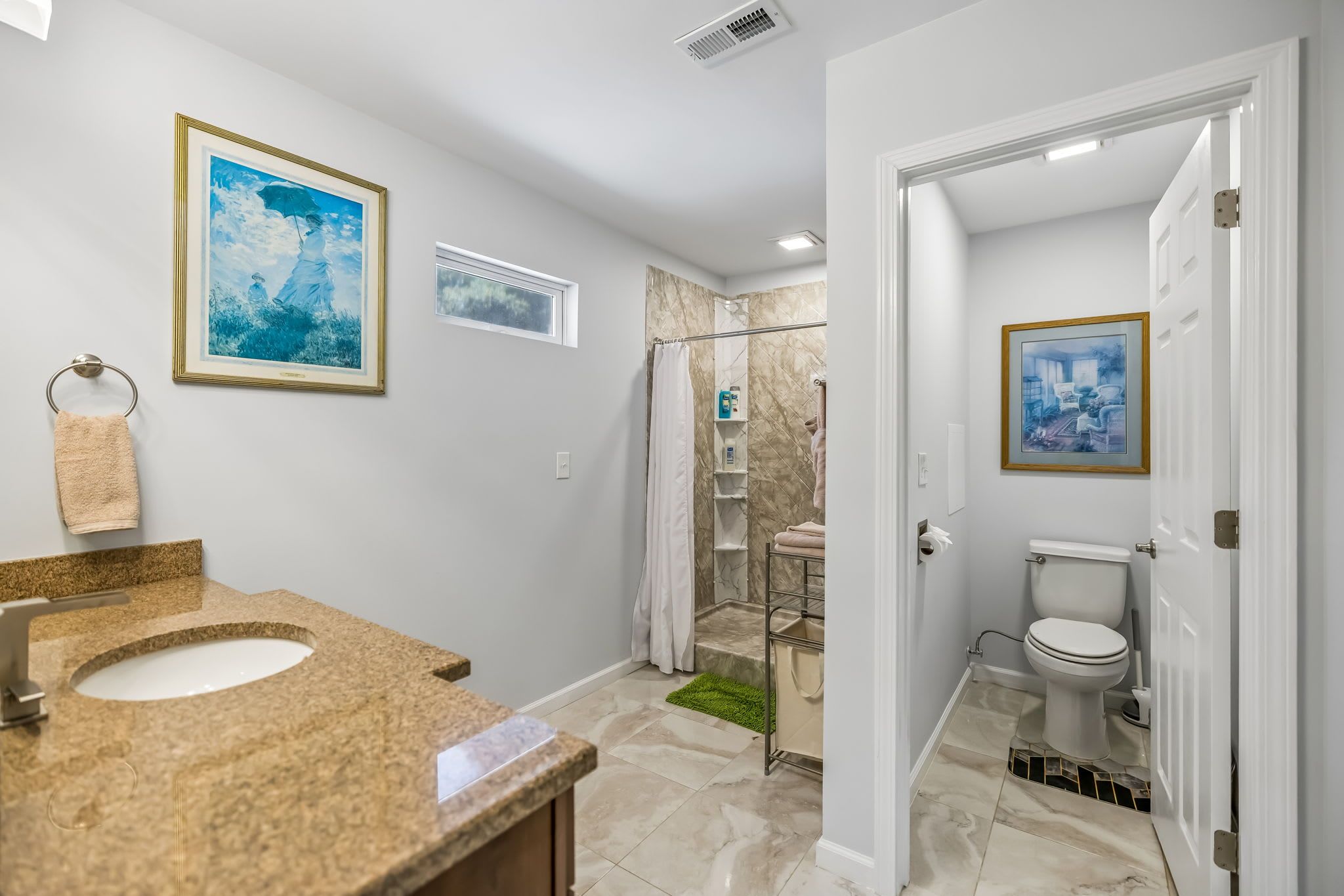 Full Bathroom 1: A clean and comfortable full bathroom with a practical layout and everyday essentials, offering a refreshing space to get ready for the day or unwind before bed.