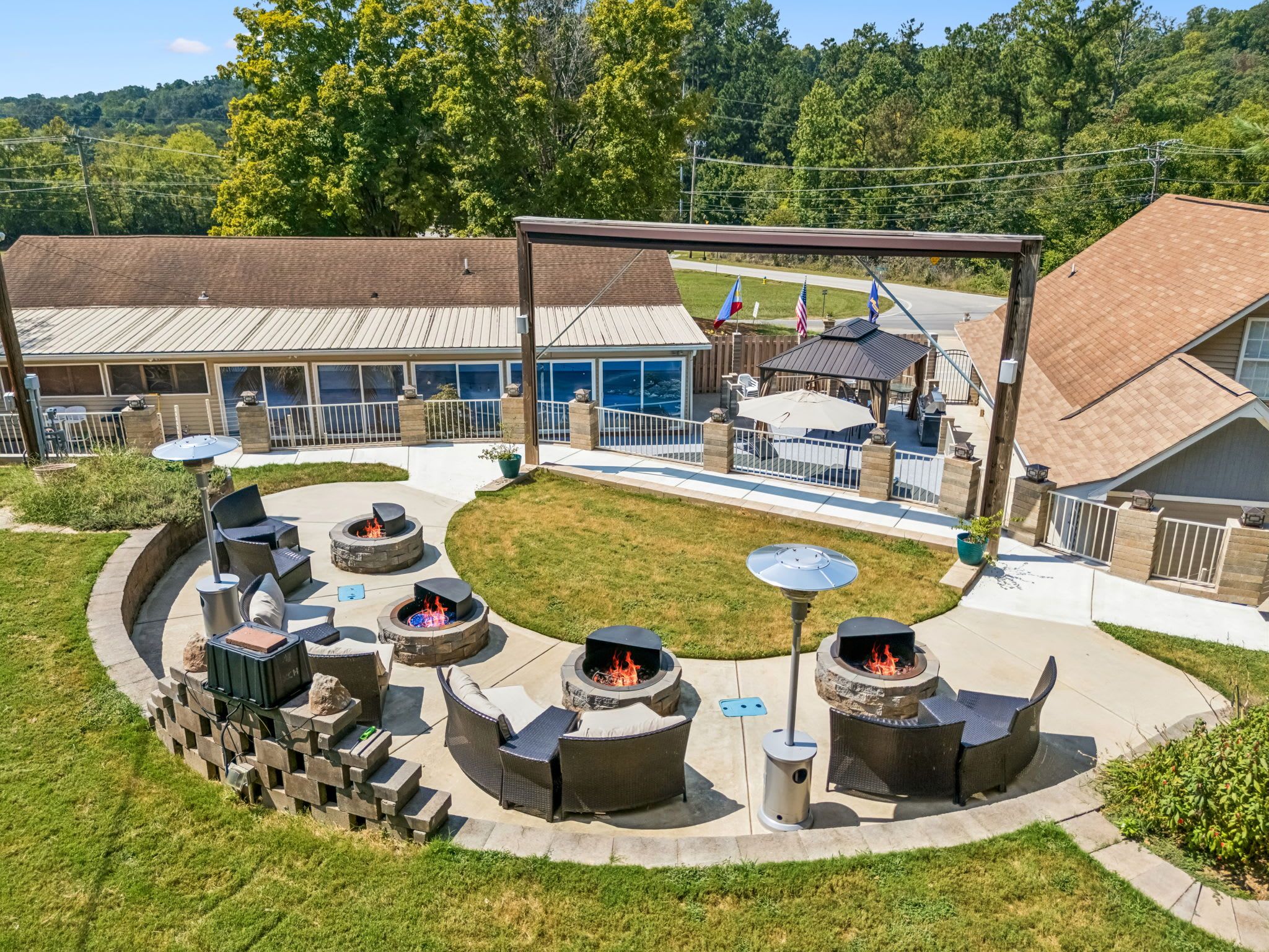 A patio area with multiple fire pits and outdoor seating.