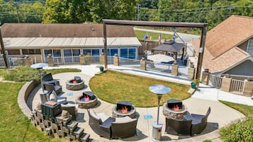 A patio area with multiple fire pits and outdoor seating.