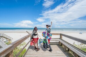 A wooden boardwalk leading to a beach with a clear sky. - Sand, Surf & Fun / Across the street from Beach + Pool & Boat Parking (St. Augustine)