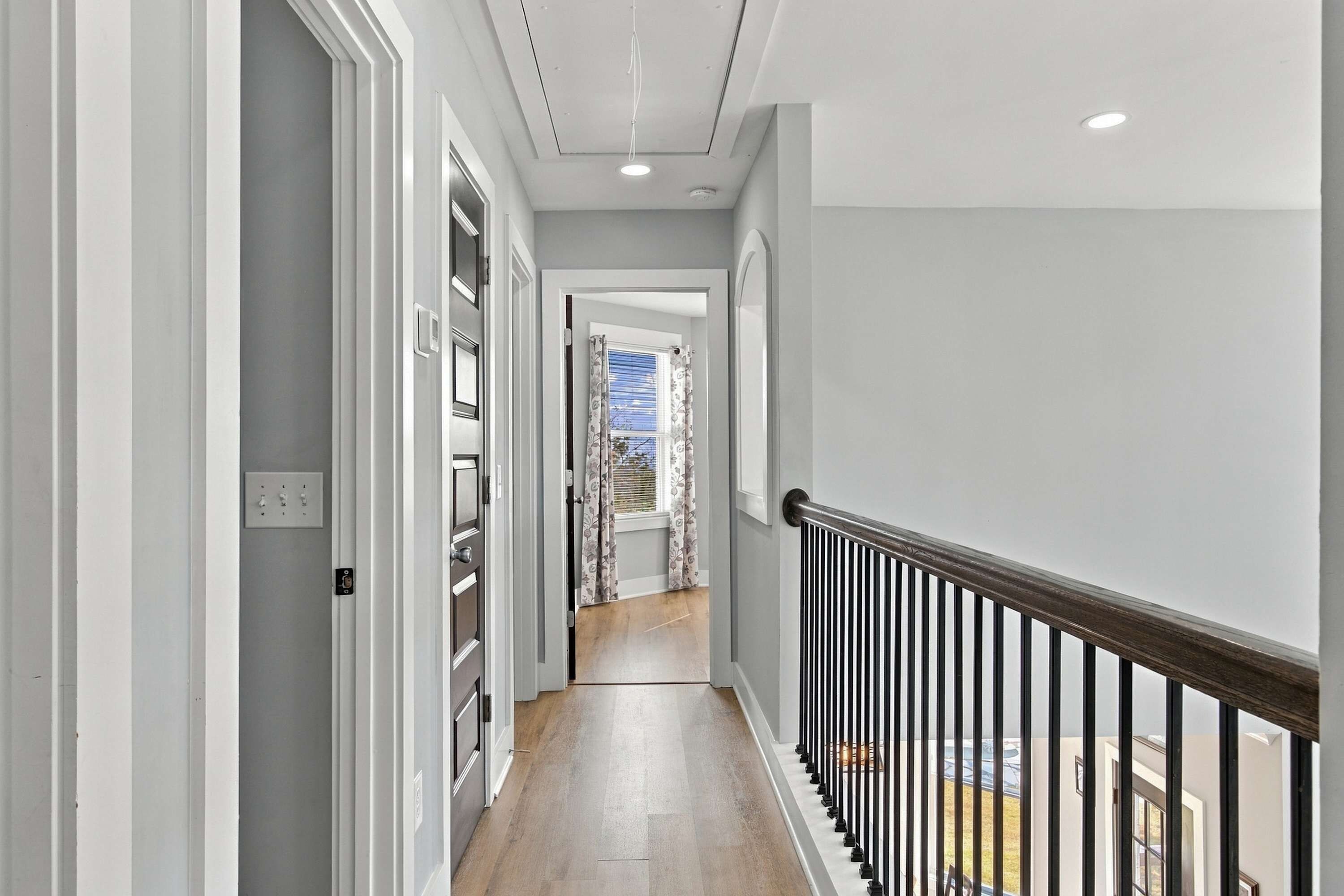 The upstairs hallway connects guest bedrooms and provides easy access throughout the second floor.