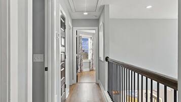 The upstairs hallway connects guest bedrooms and provides easy access throughout the second floor.