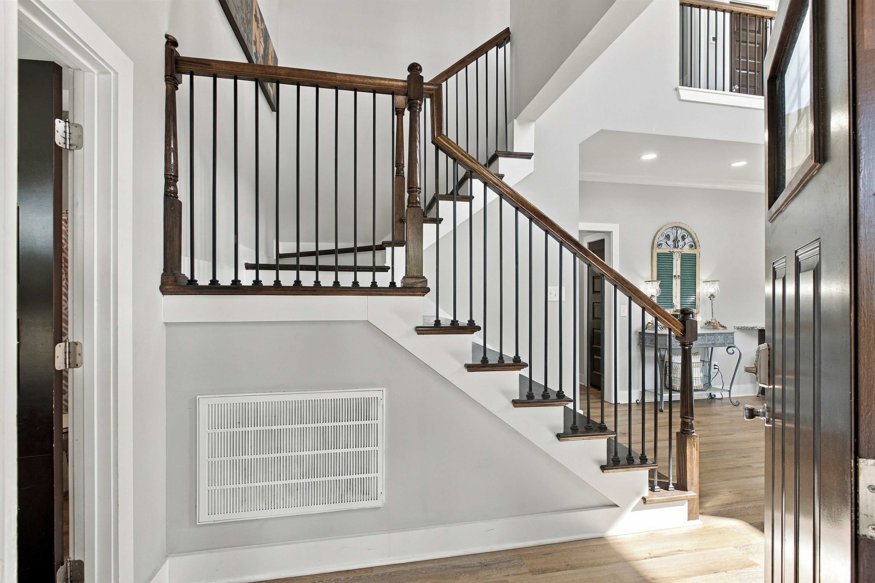 The staircase leads to additional bedrooms and gathering spaces on the home's upper level.