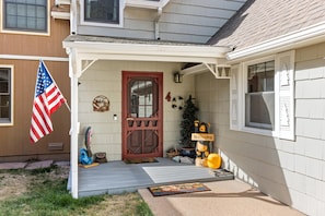 A house with a porch, a welcome sign, a bear decoration, a Christmas tree, and a welcome mat. - River Front Escape, 3 Bedrooms on River, Quite area (Estes Park)