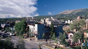 A town with a mix of modern and traditional buildings, a clear sky, and a mountain in the background. - Mountain Escape Near Breckenridge Ski Resort & Main Street (Breckenridge)