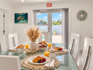 A breakfast setting with a table, chairs, and a view of the outdoors. - Private Pool BBQ Outdoor Dining (Hollywood)
