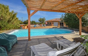 A swimming pool with a wooden deck and lounge chairs. - Amazing home in Folelli with private swimming pool, can be inside or outside (Folelli)