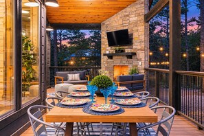Dine al fresco in the forest with a fireplace, Smart TV, and cozy seating for evenings on the deck. - Games Inside & Out | Hot Tub | Sleeps 11 (Broken Bow)