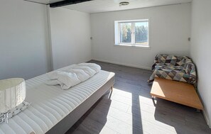 A bedroom with a single bed, a bench, a window, and a view of trees. - Amazing home in Nexø with WiFi (Nexø)