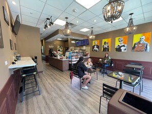 A restaurant interior with a counter, seating area, and decorative elements. - Vrbo Property (Sunny Isles Beach)