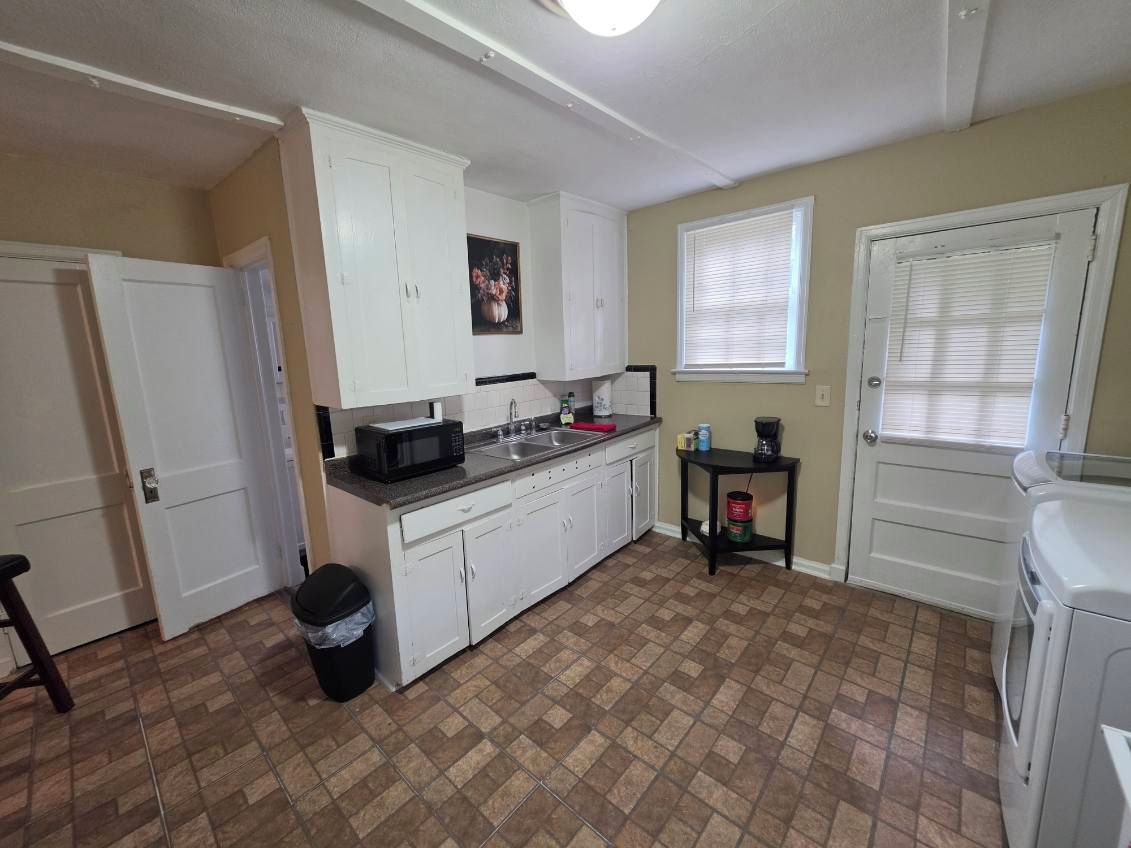 Spacious laundry room with kitchenette, coffee station, and extra storage