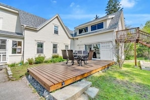 A two-story house with a deck, outdoor seating, and a small staircase leading to a second level. - Port Clyde Road (Tenants Harbor)