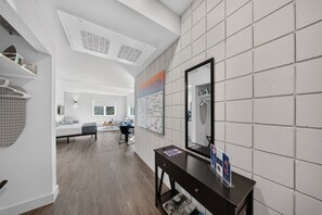 A hotel room with a large mirror, a map on the wall, and a wooden floor. - Silent Hattie Loft · Studio by Tunnel Vision Trail (Bella Vista)
