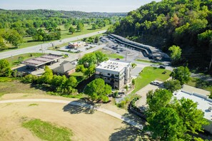An aerial view of a commercial area with parking lots, buildings, and a highway. - Rendezvous Loft · Bunk Studio Above Bike Shop (Bella Vista)