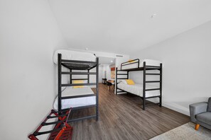 A dormitory room with bunk beds, a desk, and a chair. - Rendezvous Loft · Bunk Studio Above Bike Shop (Bella Vista)