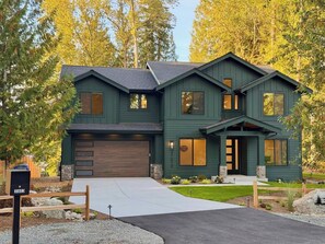 A two-story house with a garage, a front porch, and a well-maintained lawn. - The Hidden Cedar | Private Lakefront Escape (Kent)