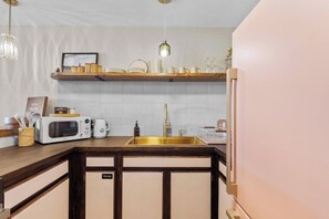 A kitchen with a microwave, coffee maker, and a sink. - The Landing at Kailua Bay (Kailua-Kona)