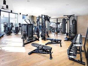 A gym with various exercise equipment, including treadmills, weight machines, and benches. - Skyline Luxe Panoramic Hollywood Views & Rooftop Pool (Los Angeles)