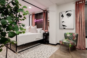 A bedroom with a bed, a chair, a neon sign, and a wall art piece. - Vintage Studio - Walk to the White House (Washington)