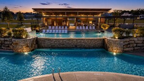 A swimming pool with lounge chairs and a covered seating area. - Firelight Cabin | Loft + 2 Baths | Sleeps 8 (Fredericksburg)
