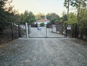 A gated entrance with a sign indicating a closed gate and a surveillance warning. - Casa Tranquilla in Evergreen, San Jose (San Jose)