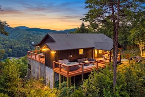 A cabin with a deck, a hot tub, and a fireplace. - Stone Ridge Summit: Pet Friendly, Mtn Views, Hot Tub, Game Room, Firepit + More (Sevierville)