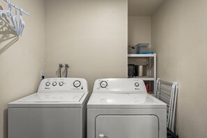 A laundry room with two front-loading washing machines and a dryer. - 16 Mountain Shadows 3BR completely remodeled Incline Village Mtn Views (Incline Village)