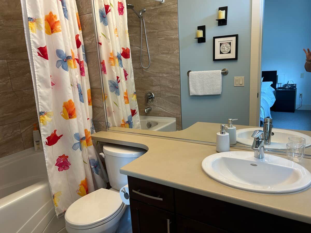 A bathroom with a bathtub, toilet, and sink.
