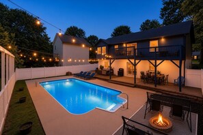 A backyard with a swimming pool, outdoor seating, and a fire pit. - 5-bedroom Getaway w/ Private Pool, Arcade, Pool Table & More (Gastonia)