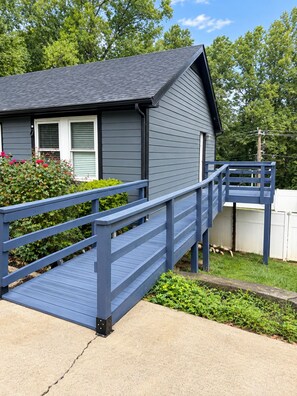 A house with a blue wooden deck leading to a front door. - 5-bedroom Getaway w/ Private Pool, Arcade, Pool Table & More (Gastonia)