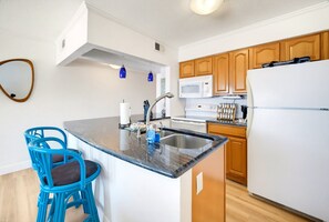 Kitchen with full-size refrigerator, stove and microwave