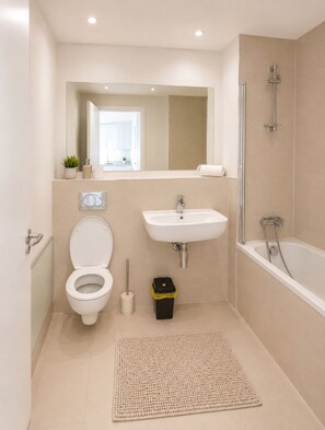 A modern bathroom with a toilet, sink, and shower. - Two bedroom two bathroom at Croydon city center (Croydon)
