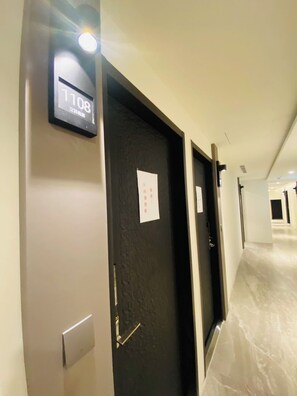 Un pasillo con una puerta marcada '108' y un letrero con caracteres chinos.