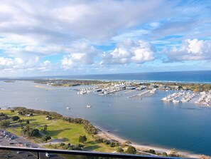 A marina with boats docked, a beach, and a parking area. - Panoramic Ocean 2BR, Gold Coast Spa & Pool (Southport)