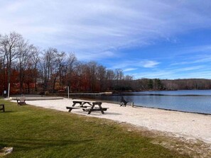 A lakeside park with picnic tables and a bench. - The Hive at Big Bass Lake (Big Bass Lake)