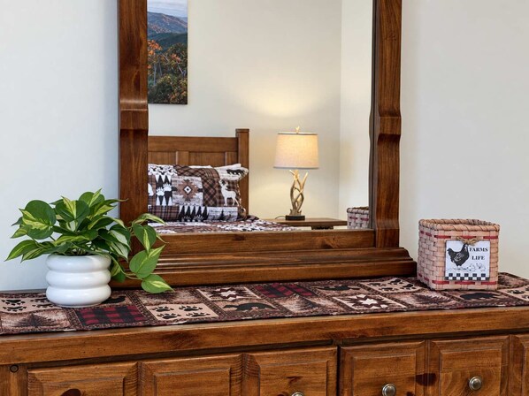 Small touches on the dresser carry the cabin feel through Bedroom 2.