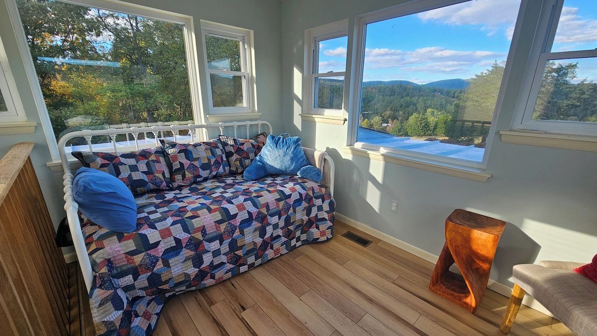 A cozy room with a bed, a window, and a view of the outdoors.