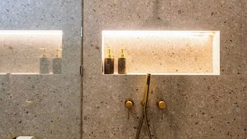 Un baño con ducha, inodoro y lavabo con espejo.