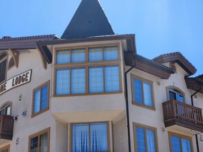 A building with a sign reading 'Lodge' and multiple windows with blinds.