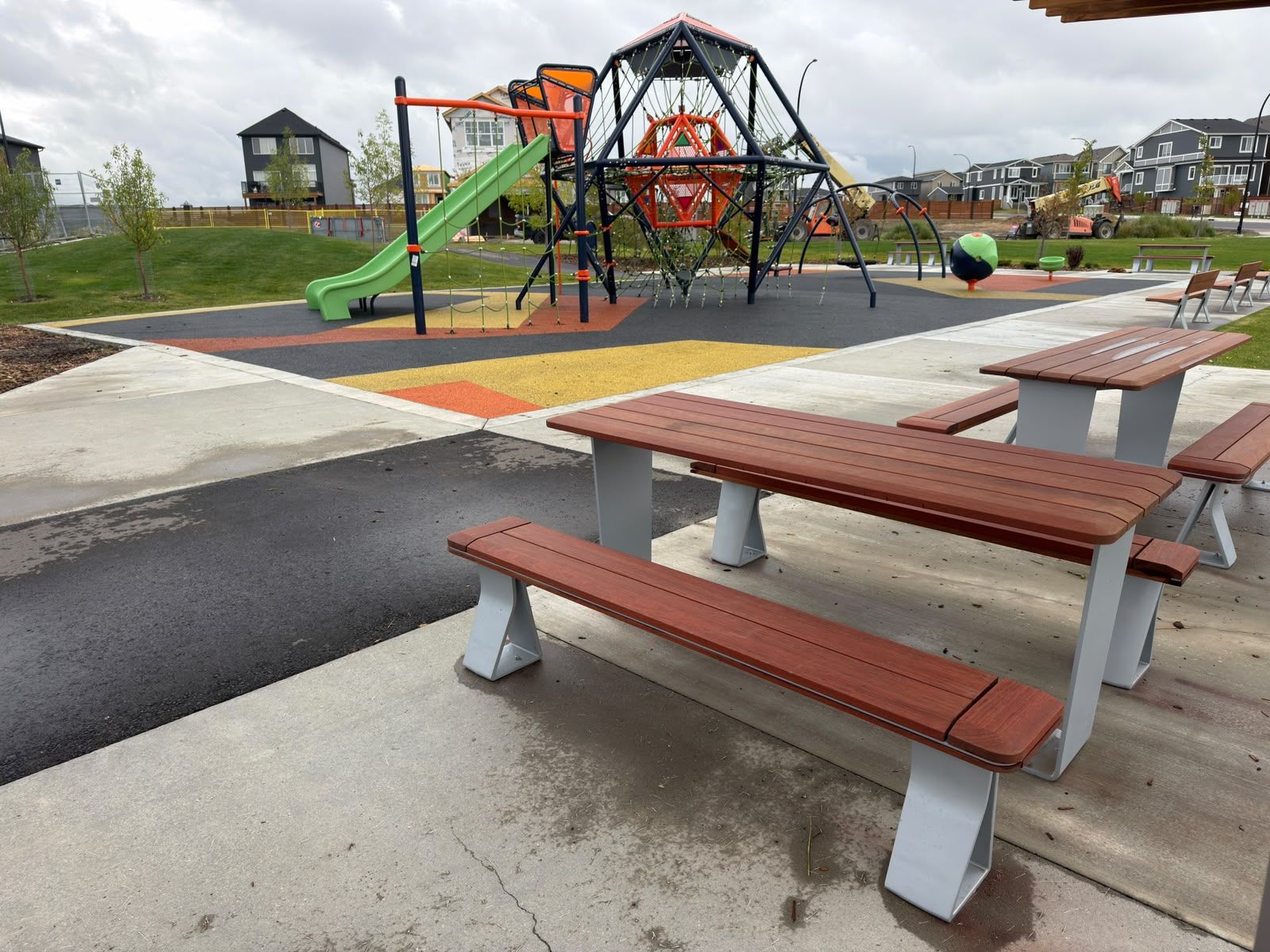 A playground with a slide, swings, and a climbing structure.