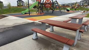 A playground with a slide, swings, and a climbing structure.